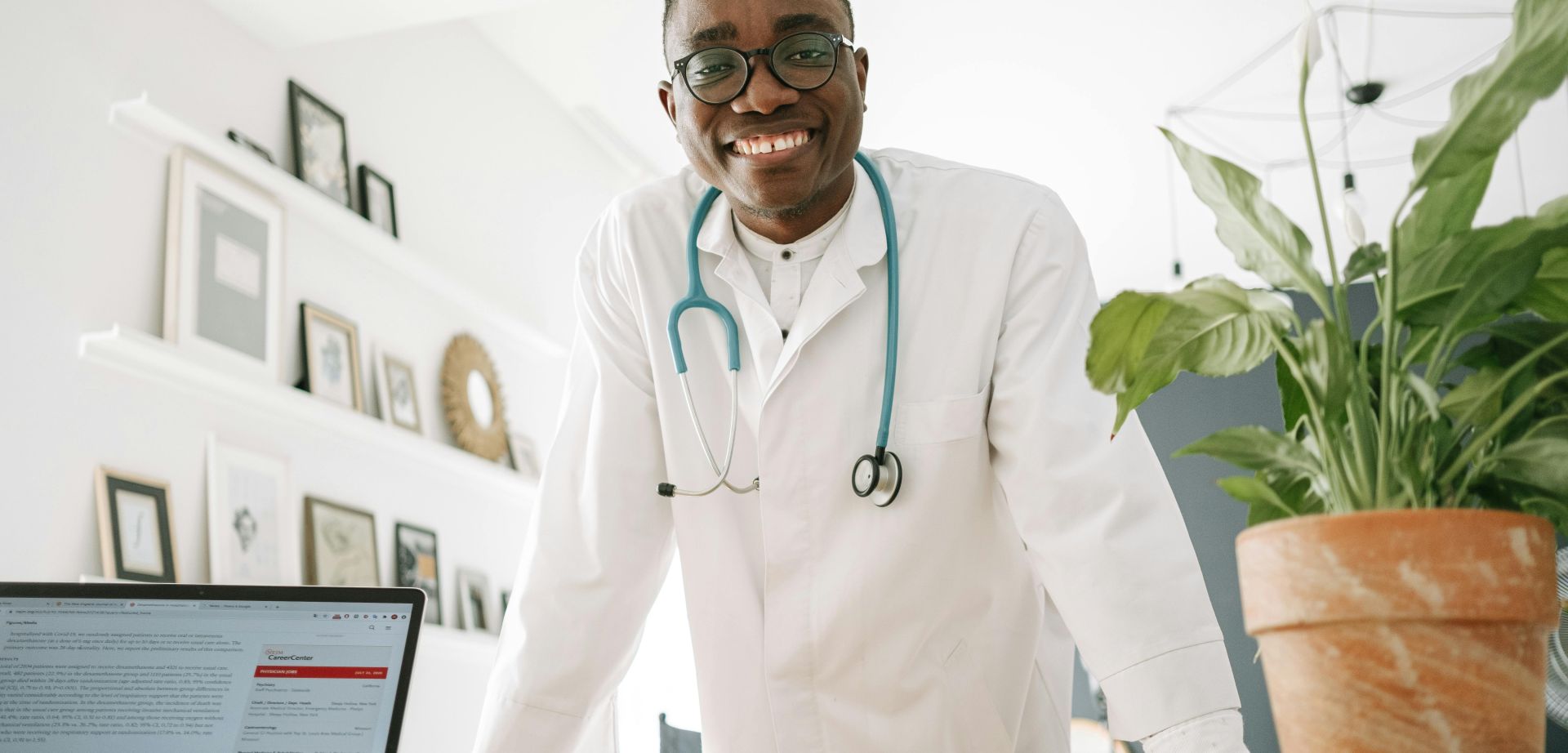 A Doctor Smiling while Leaning on the Table